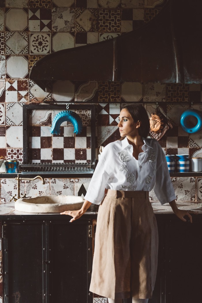 In the kitchen at I Casali del Pino. She wears Fendi embroidered linen shirt, POA, and linen trousers, POA, both from the spring/summer 2021 collection