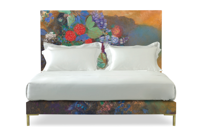 A bed with two head pillows and a flower-designed headboard