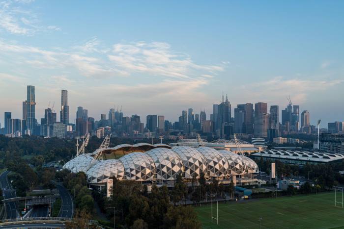 An aerial short of the AAMI Park stadium, with Melbourne’s skyline in the background