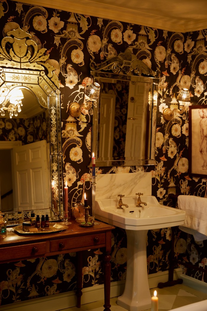 The guest bathroom, with Euphoria wallcovering and vintage mirrors from Venice