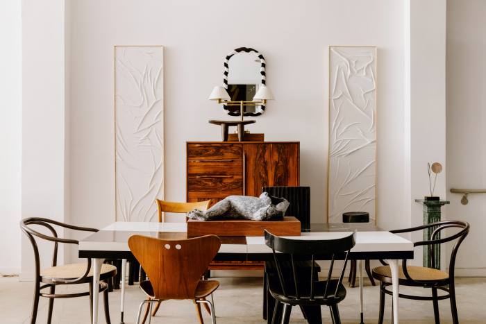 Thonet 209 wicker accent chairs, $1,050. Irregular Arne Jaconsen for Fritz Hansen Series 7 chair, $625. Paul McCobb black chair, $395. Danish Modern Rosewood Armoire, $3,450. A pair of Dot Loewenthal abstract plaster paintings, $2,200 each