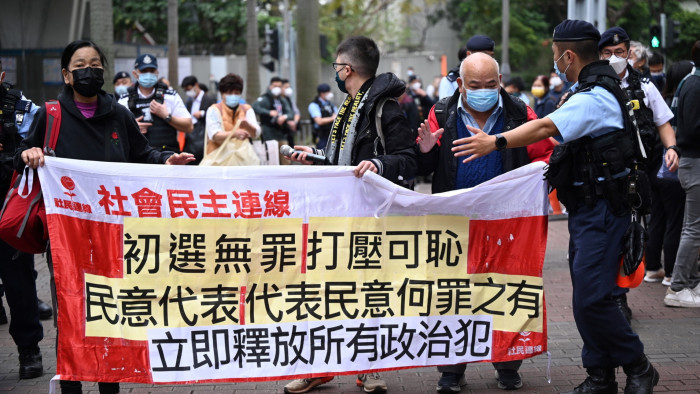 Members of the League of Social Democrats carry a banner outside a court in Hong Kong on February 6 2023  