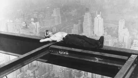 A workman takes a siesta on a girder during the building of Radio City in New York in 1933
