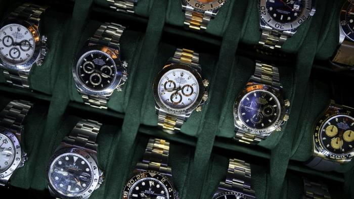 A collection of wristwatches neatly arranged in rows
