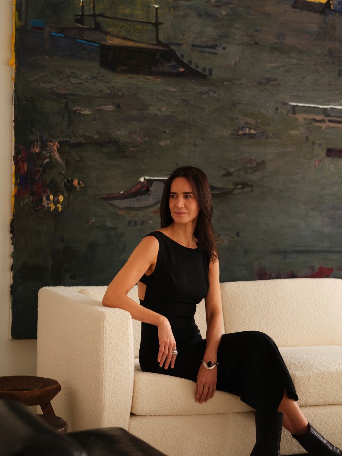 Khouri in front of a painting by Brazilian artist Marina Rheingantz