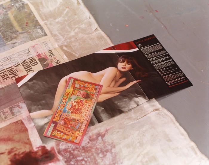 Source materials in her studio, including Hell money and Penthouse magazine
