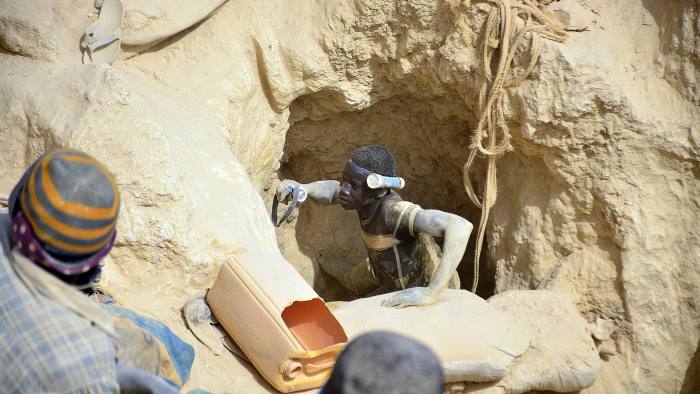 Workers in a clandestine gold mine