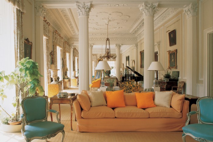 Orange cushions on a Hicks sofa in the Long Gallery at Baronscourt, which Hicks returned to its original length in 1978