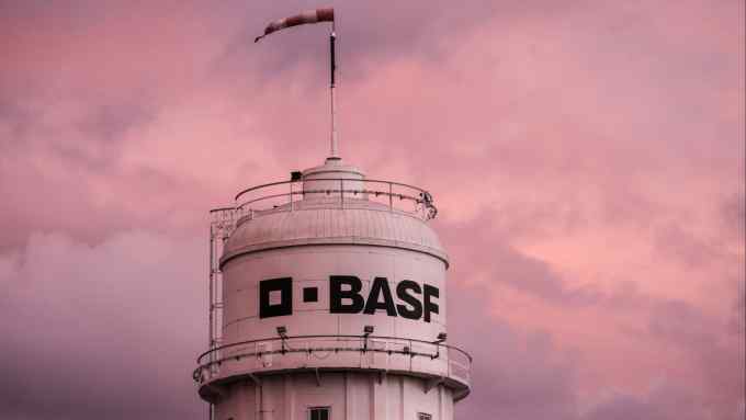 BASF plant stands at sunset behind a stop sign