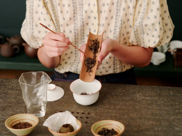 Brushing tea leaves into a gaiwan