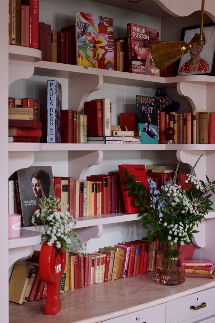 Bookshelves fitted under the mezzanine floor, and a Philip Colbert lobster vase. The brass light is by Soane