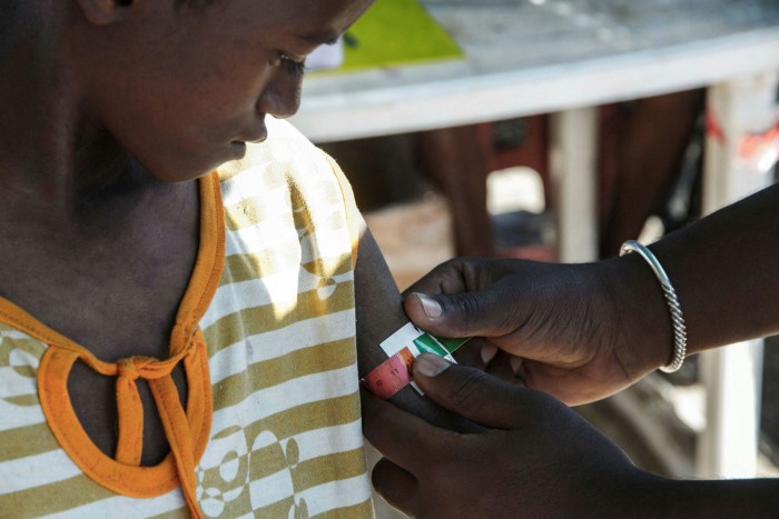 A nurse in Madagascar prepares to give antibiotics to a boy showing signs of severe malnutrition 