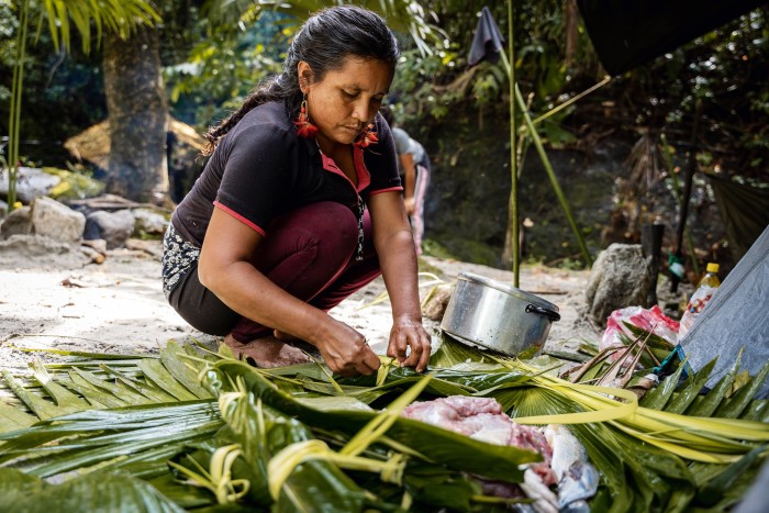 An indigenous woman prepares food in the Ecuador rainforest – the Honnold Foundation partners with the Ceibo Alliance to help defend rainforest from illegal extraction