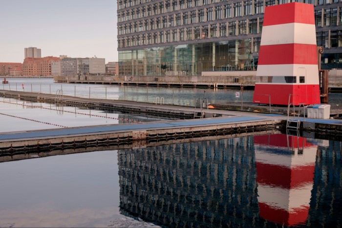 The pools at Fisketorvet harbour baths, Copenhagen, with a red and white striped lifeguard tower to the side 