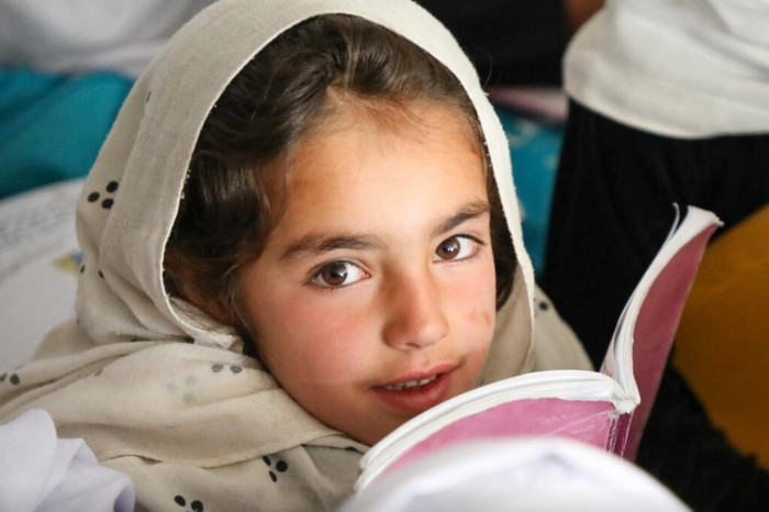 female Afghan child with a notebook 