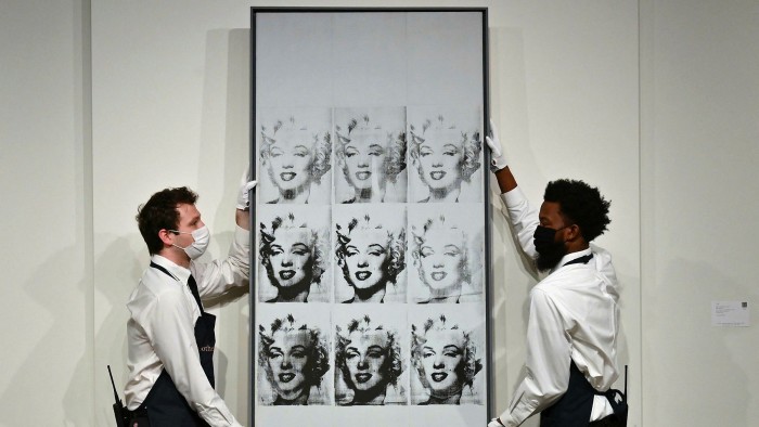Art handlers hang Andy Warhol’s ‘Nine Marylins’ at Sotheby’s