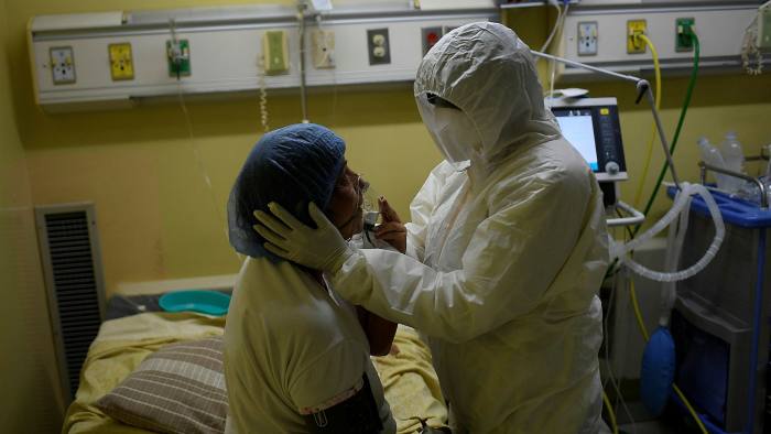 A Covid-19 patient undergoes treatment at a hospital in Venezuela’s capital, Caracas. More than 60,000 health workers have benefited from the funds unfrozen in the US — Matias Delacroix/AP