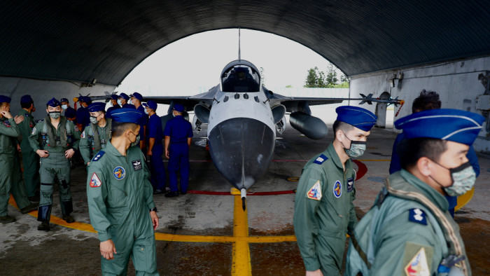 Taiwanese Air Force pilots walk past next to an AIDC F-CK-1 Ching-Kuo, commonly known as the Indigenous Defense Fighter, in Penghu