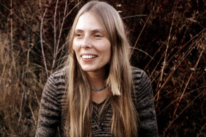 Musician Joni Mitchell keeps it poker straight and below the shoulders for the release of Blue, 1971