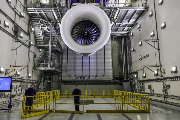 Employees prepare a Trent XWB jet engine