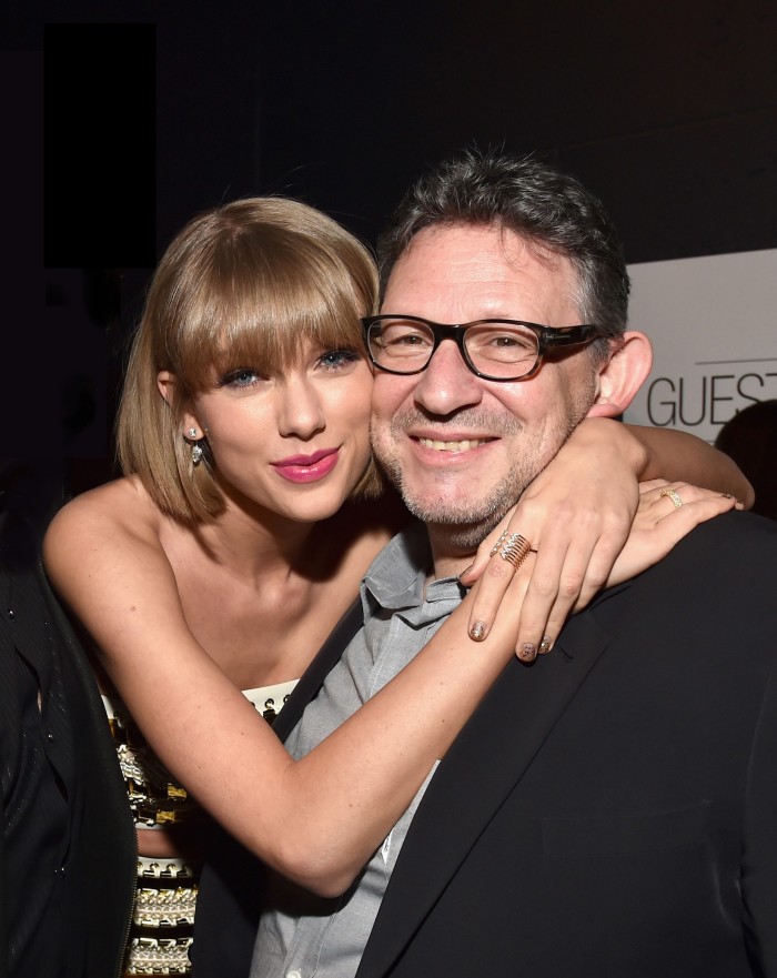 Music artist Taylor Swift hugging music executive Lucian Grainge