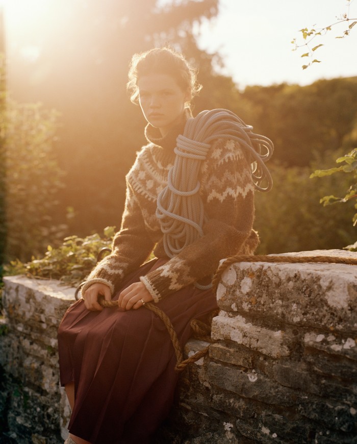 Luca Biggs visits Burgh island in Devon. She wears vintage Céline wool jumper, £700, resee.com. Ecoalf recycled polyester skirt, £275