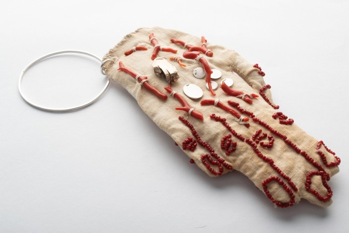 a bracelet, ‘Self Portrait with Corals’, featuring a hand that was made from what looked like linen, embellished with silver, gold, coral and glass beads