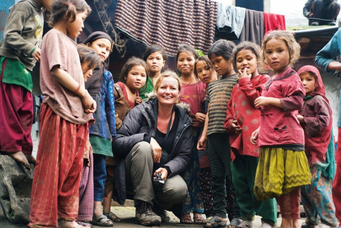 Founder Zara Balfour in the Himalayas with village children