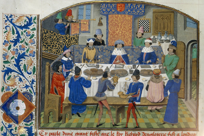 A coloured drawing taken from a medieval book of kings dining around a table