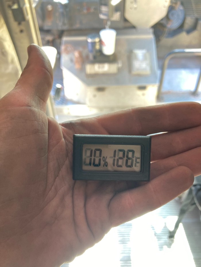 A thermometer reading from inside the cargo area of a UPS delivery truck