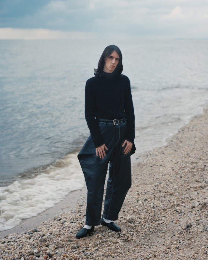 Juju wears Saint Laurent by Anthony Vaccarello wool turtleneck, £715. JW Anderson leather trousers, POA. Lemaire leather shoes, $520. Belt and socks, stylist’s own