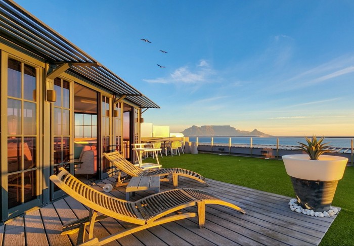 outdoor wooden decking and chairs with mountain in the distance