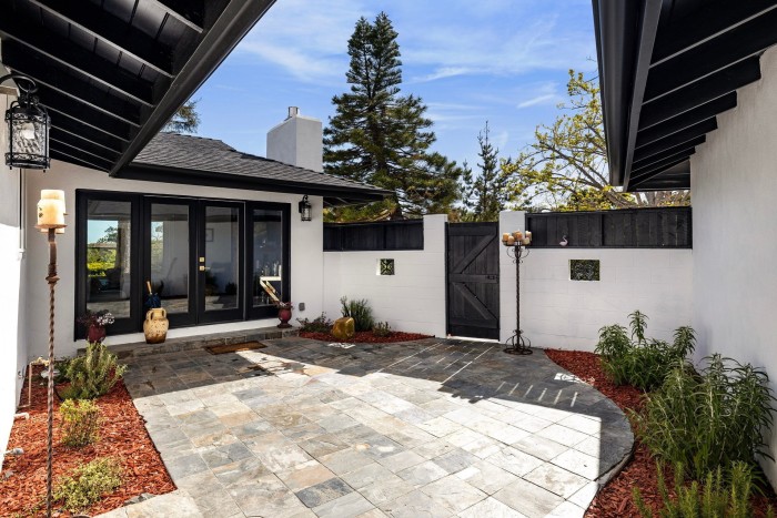 A black and white house with a sunny courtyard-style garden, $3.875mn