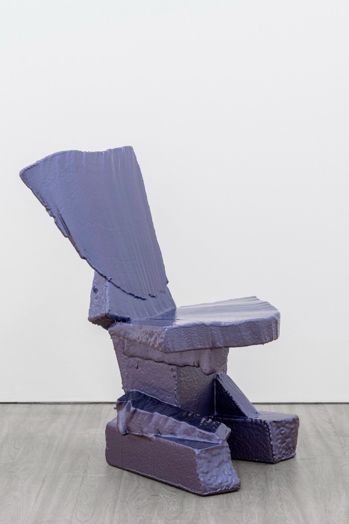 A chair apparently made from polystyrene blocks painted lurid mauve