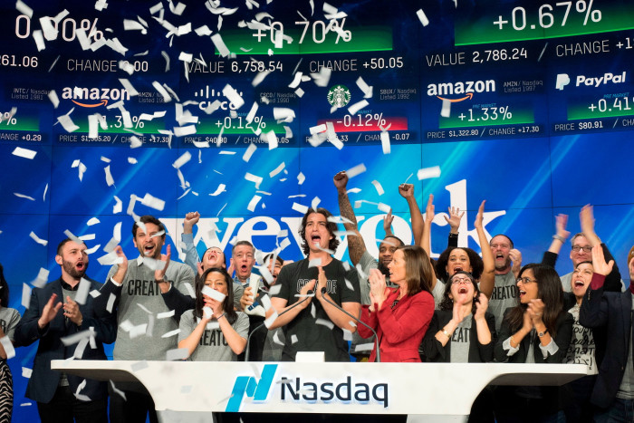 Adam Neumann, centre, co-founder and chief executive of WeWork, attends the opening bell ceremony at Nasdaq in New York in January 2018
