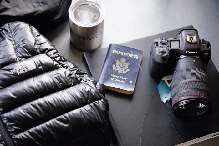 His Canon EOS 5D camera next to his well-worn passport 