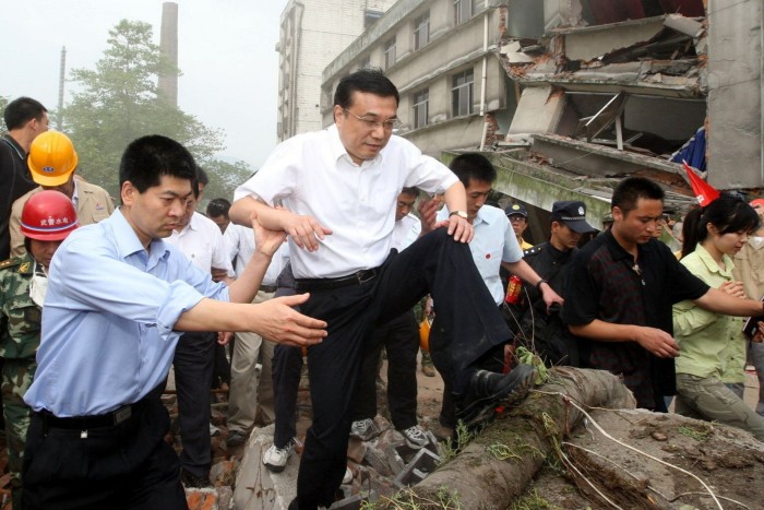 Li Keqiang walks on debris in Beichuan county, in south-west Sichuan province, after an earthquake in 2008