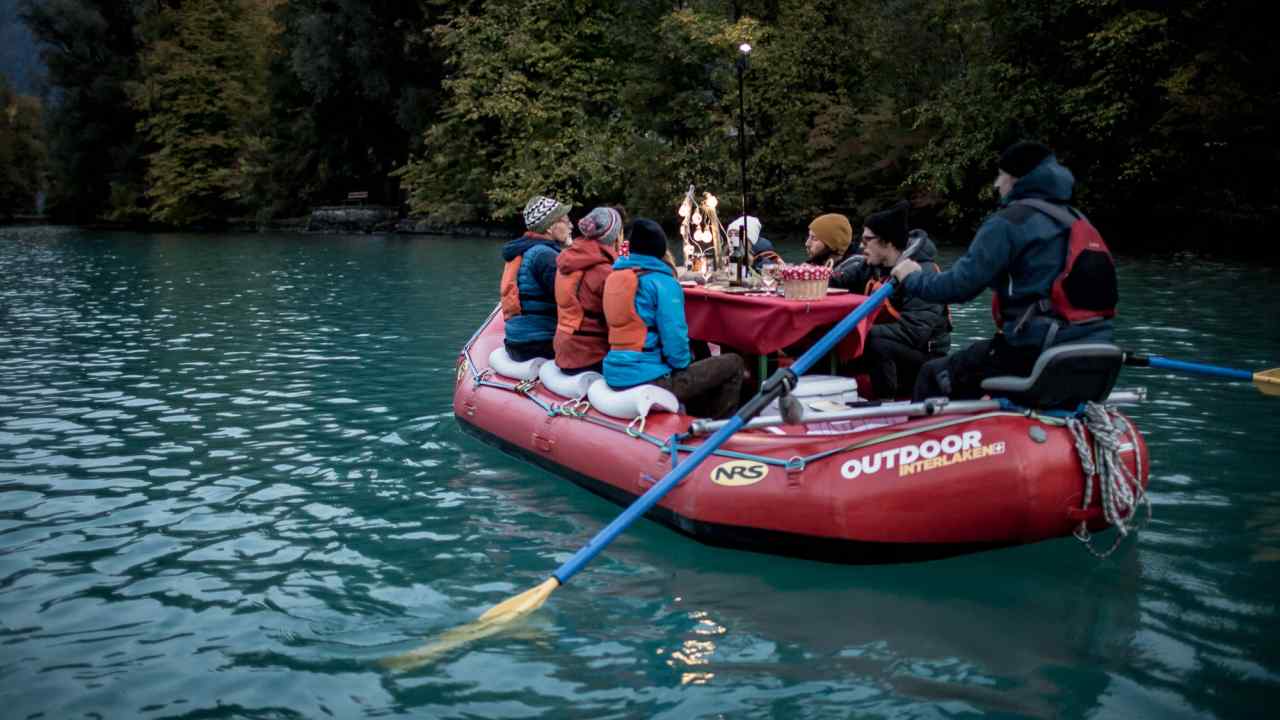 People sit on a raft on a river
