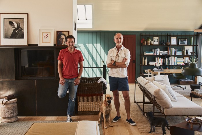 Konig, left, and Brown in the open-plan living and dining room, with daybeds by Stephen Kenn, and Sunny the dog