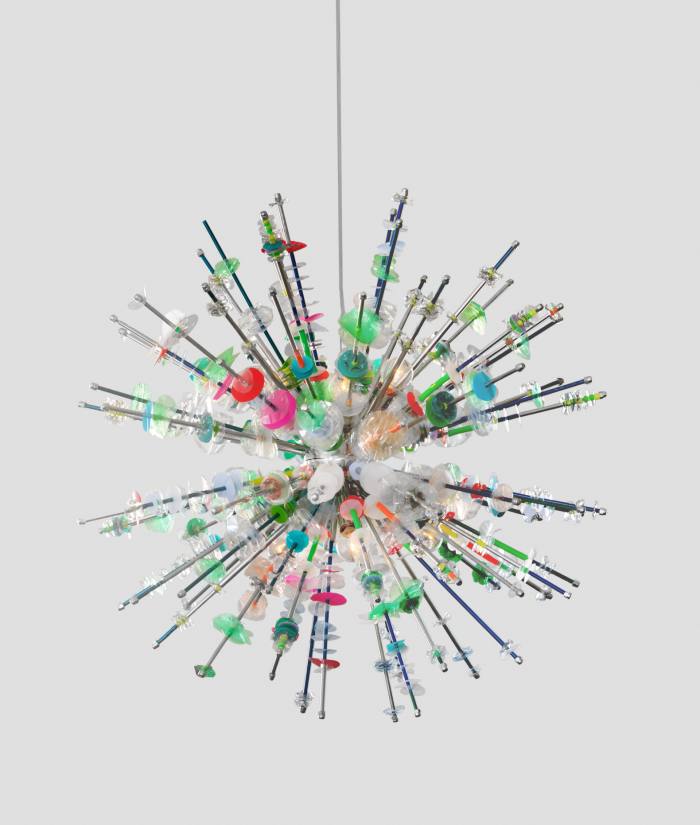 A hanging light made of spikes covered in colour plastic parts