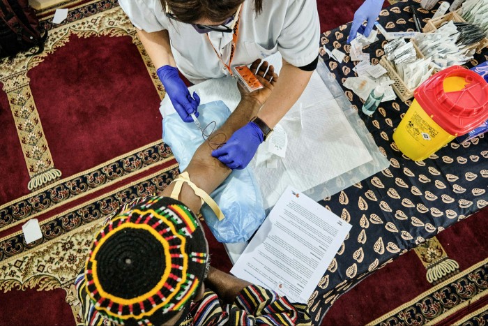 At the sharp end: a volunteer nurse with HBV-Comsava takes a blood sample in a mosque