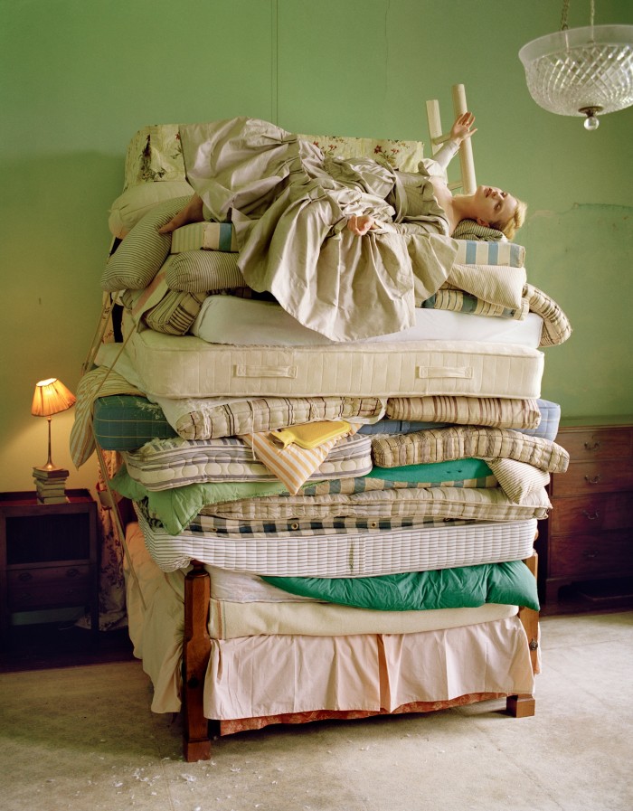 Guinevere van Seenus, 20 mattresses and 1 hot water bottle. Fashion: Vivienne Westwood, Glemham Hall, Suffolk, England, 2006, by Tim Walker