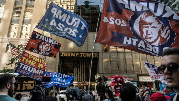 Trump supporters gather in front of Trump Tower in New York ready for a press conference by the former president