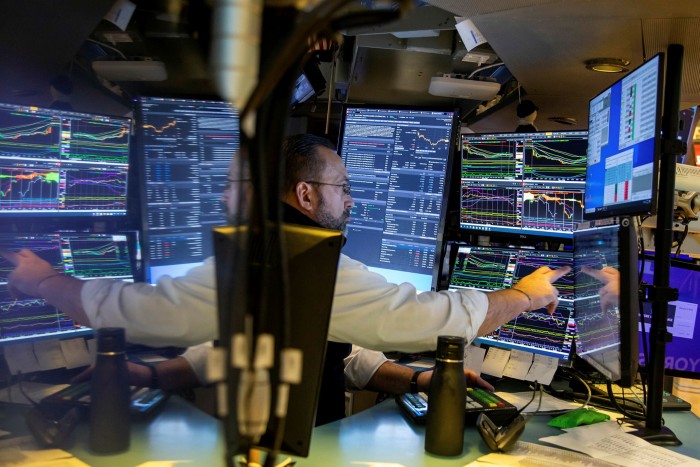 A trader works on the floor of the New York Stock Exchange 