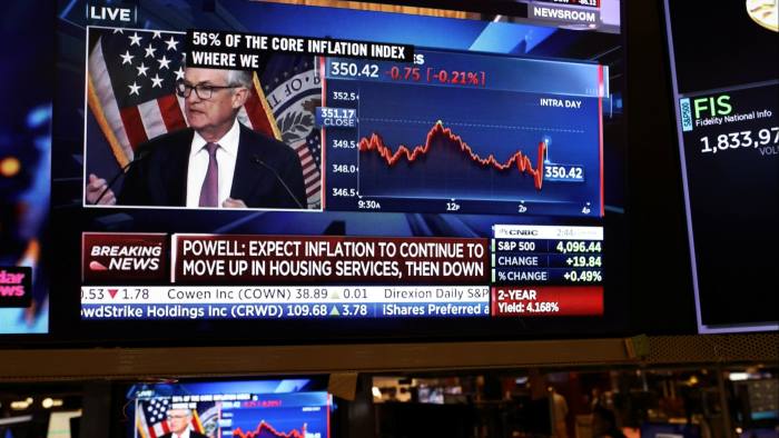 Federal Reserve chair Jay Powell appears on a screen on the trading floor of the New York Stock Exchange following a Fed rate announcement