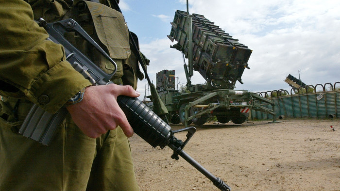 An Israeli soldier stands alongside a Patriot missile launcher as the anti-aircraft and anti-ballistic missile missile is made ready to launch