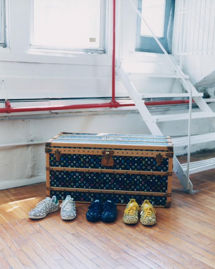 Louis Vuitton monogram steamer trunk with (from left) white, navy and yellow Adidas Swarovski-crystal Stan Smith sneakers