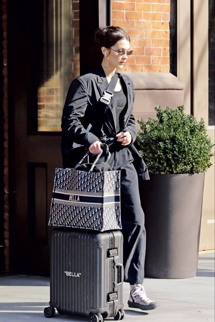 Bella Hadid with her personalised Rimowa x Off-White case
