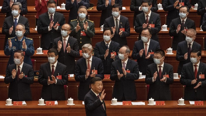 Chinese President Xi Jinping, front, is applauded as he waves to senior members of the government as he arrives at the 20th Chinese Communist party conference at the Great Hall of the People in Beijing