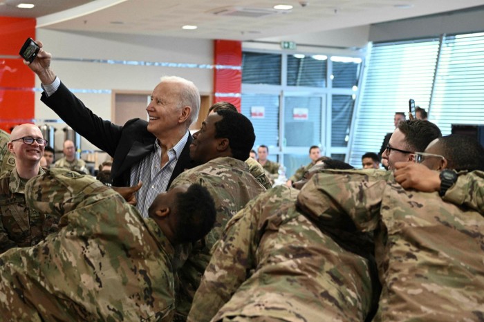 US President Joe Biden takes a selfie with US troops in Poland